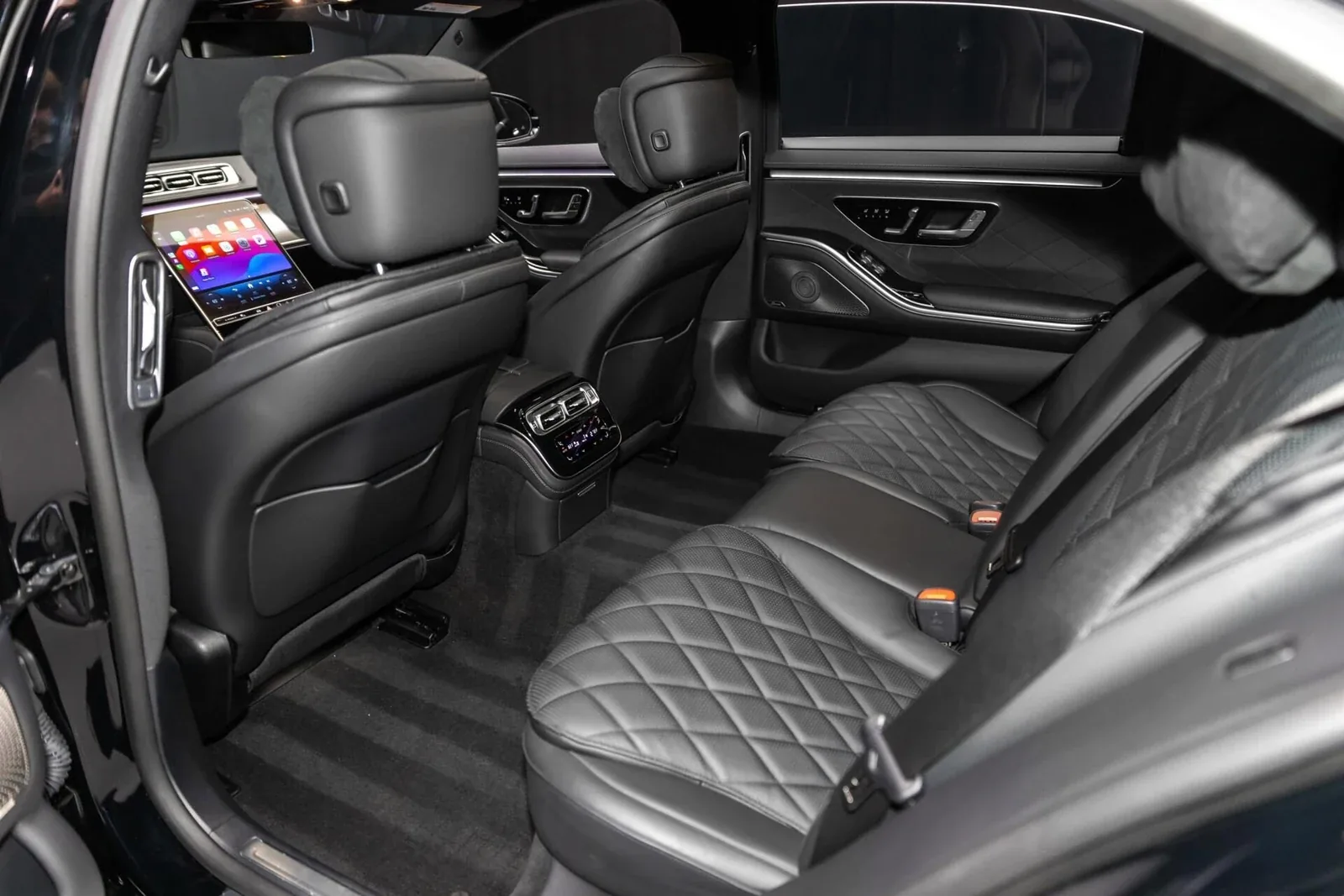 Interior of a black luxury sedan on a Los Angeles road at golden hour