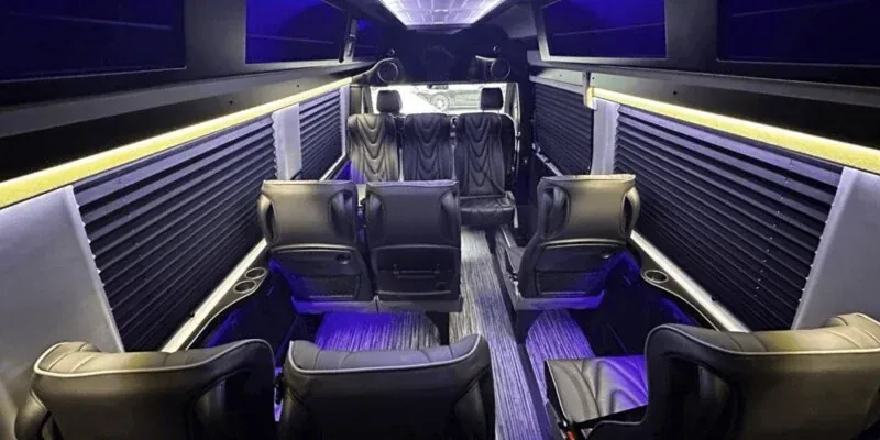 Interior of an executive Mercedes Sprinter van with captain's chairs, set up for a Los Angeles wedding party